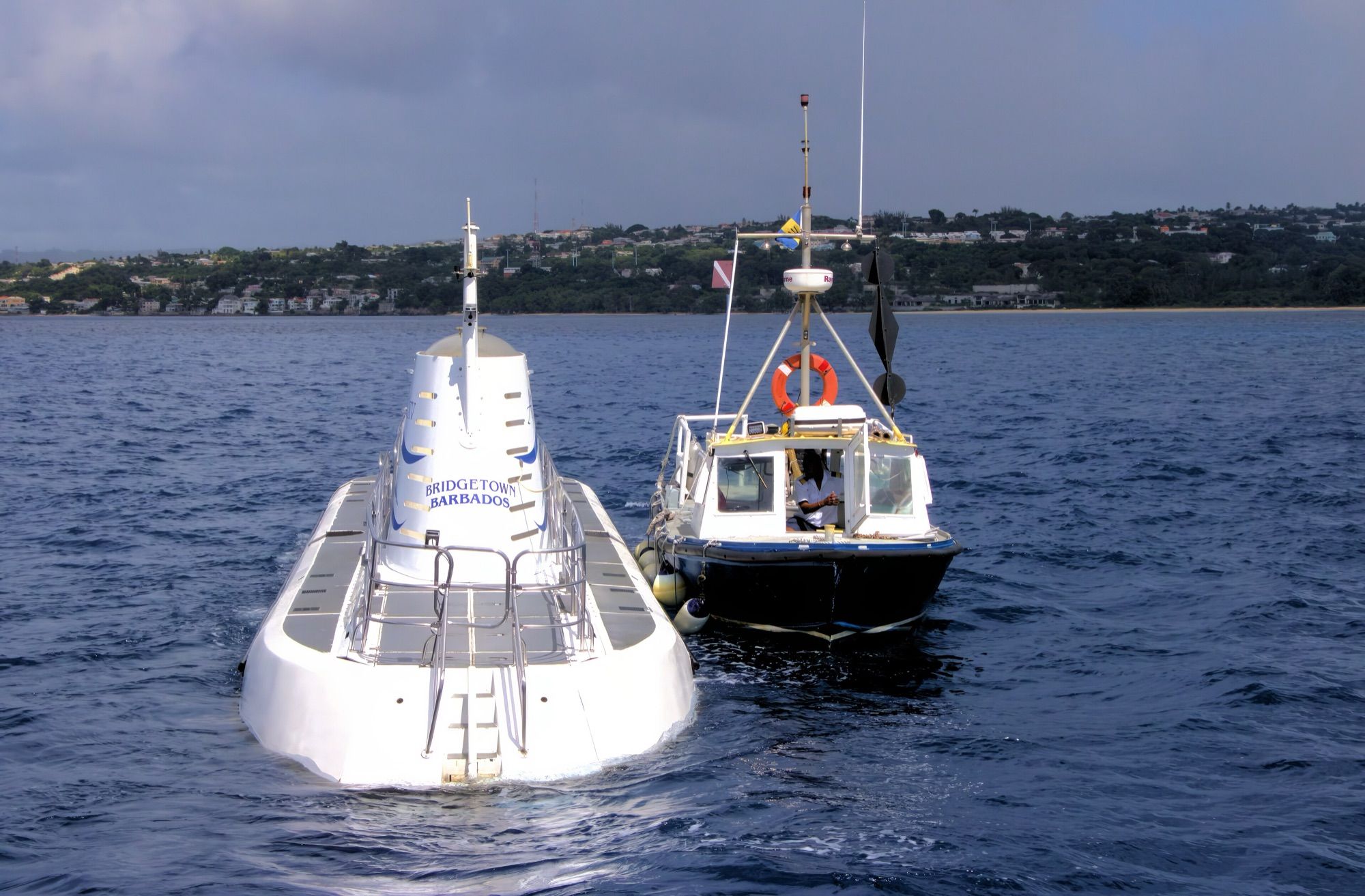 Atlantis submarine alongside its shuttle boat off the Barbados coast