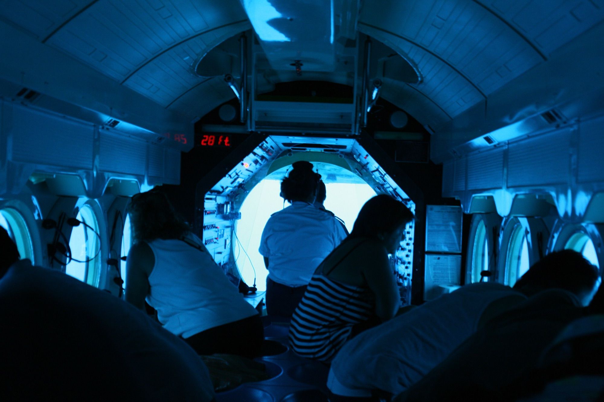 Passengers seated at the viewports inside an Atlantis submarine