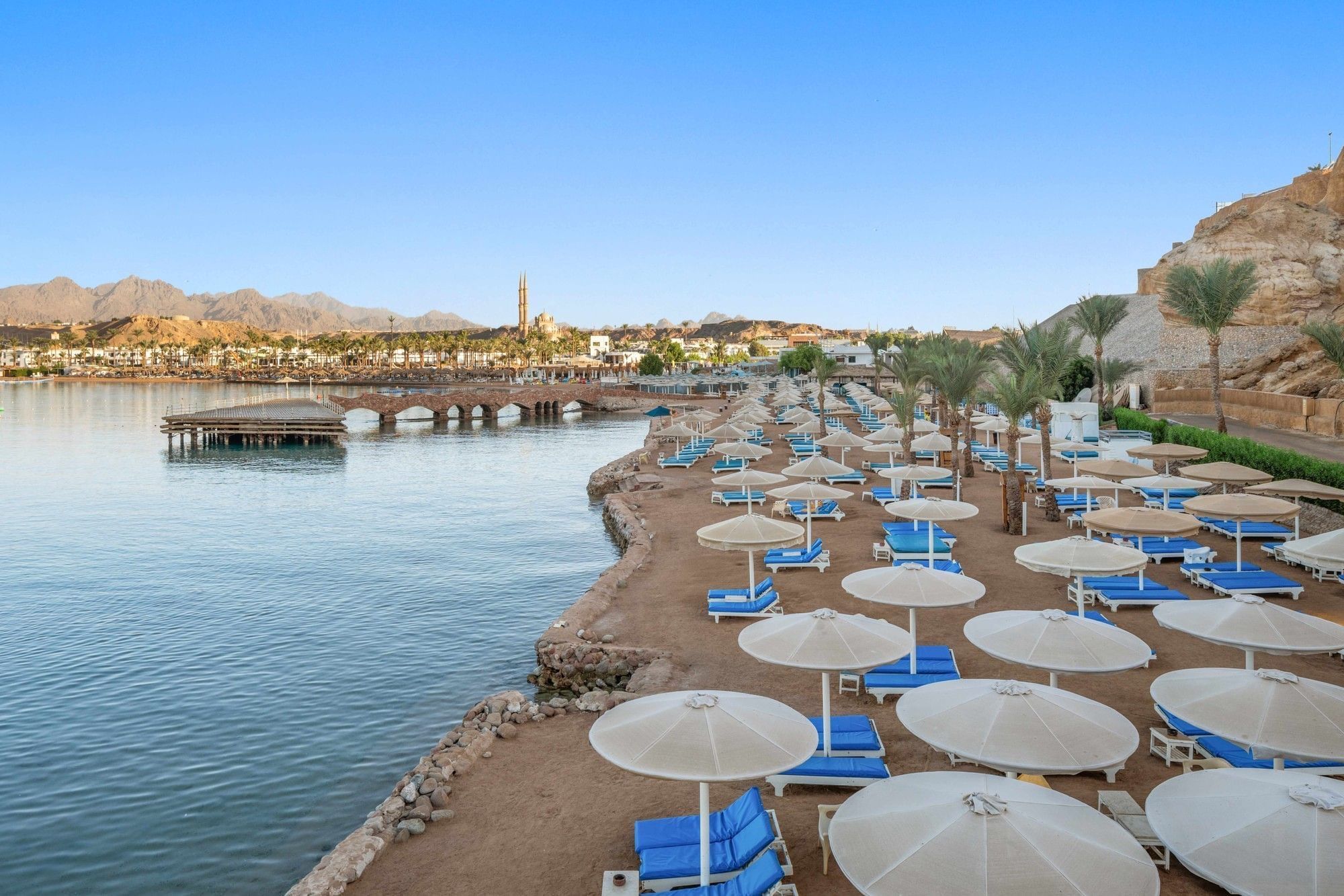 Beach with parasols on the bay below Albatros Sharm Resort
