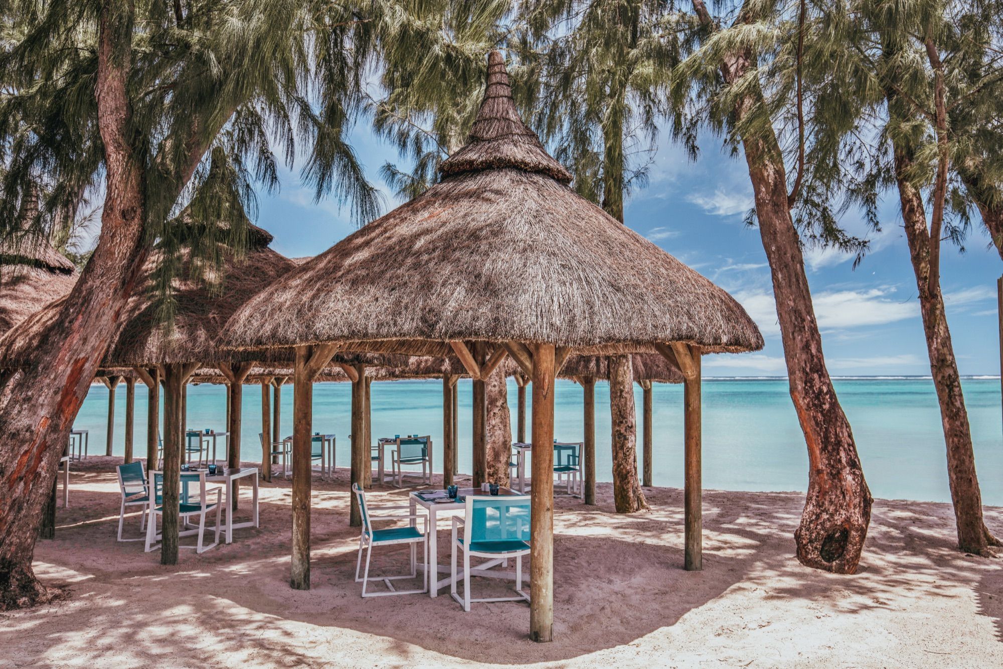 Thatched tables at La Plage seafood restaurant on the beach