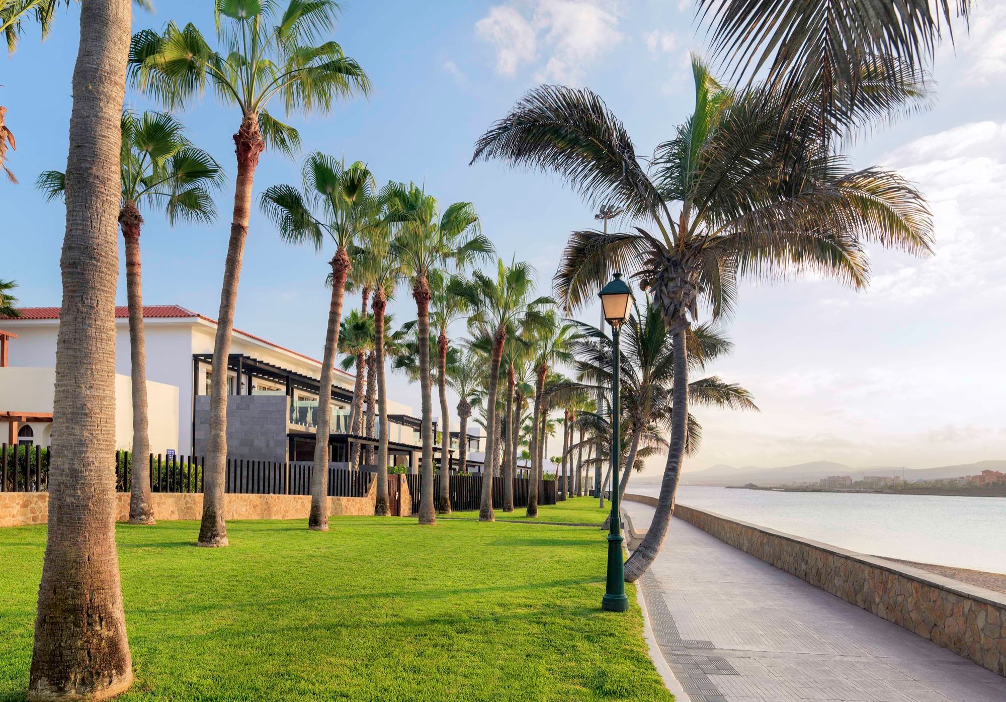 Seafront promenade and palm-lined gardens of the resort