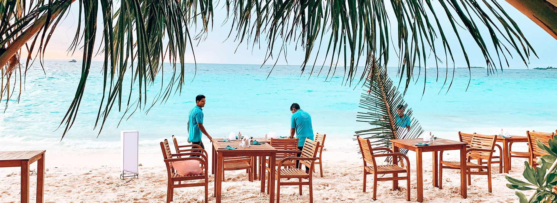 Tables set for dinner on the beach at Dhigurah