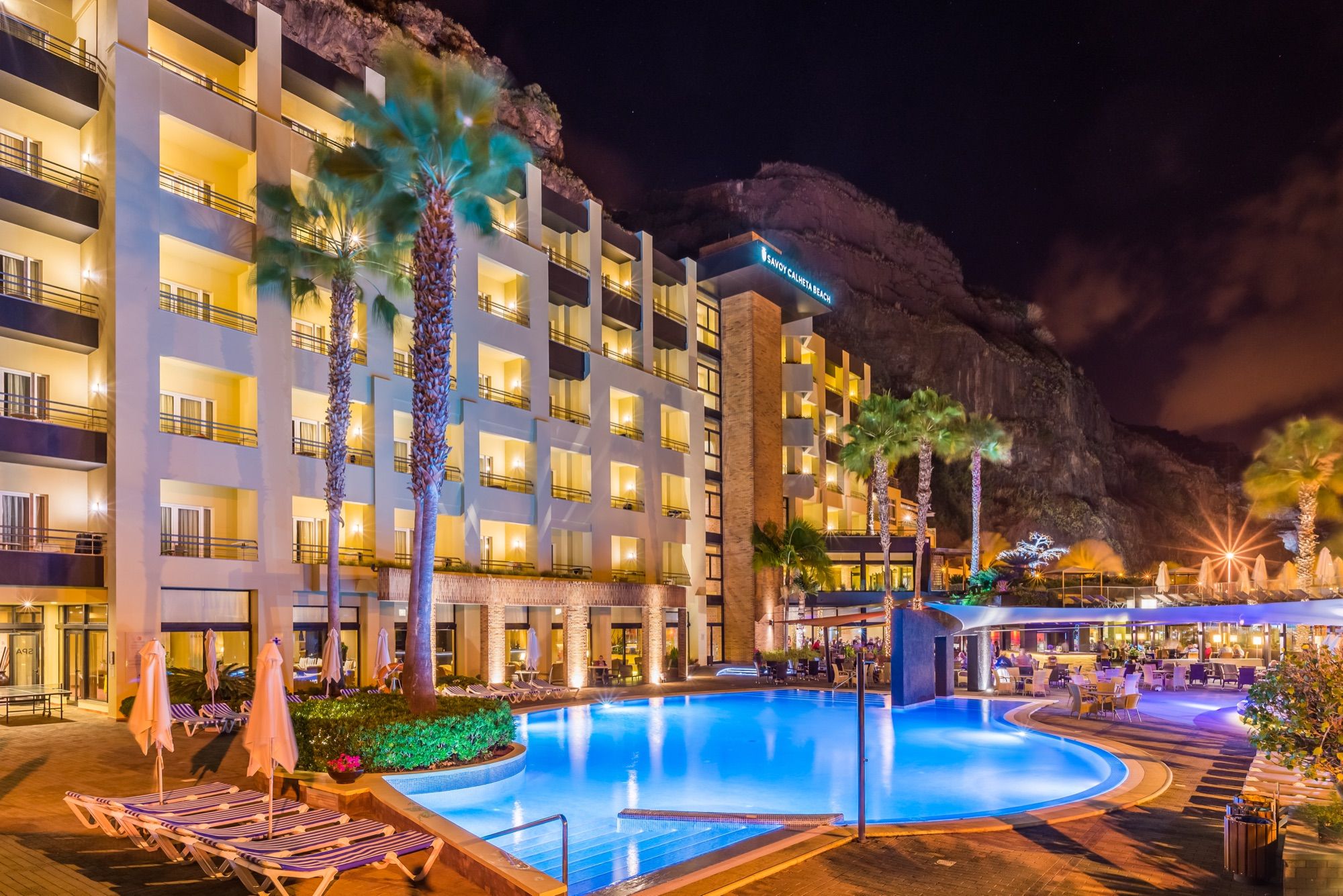 Pool and hotel lit up at night