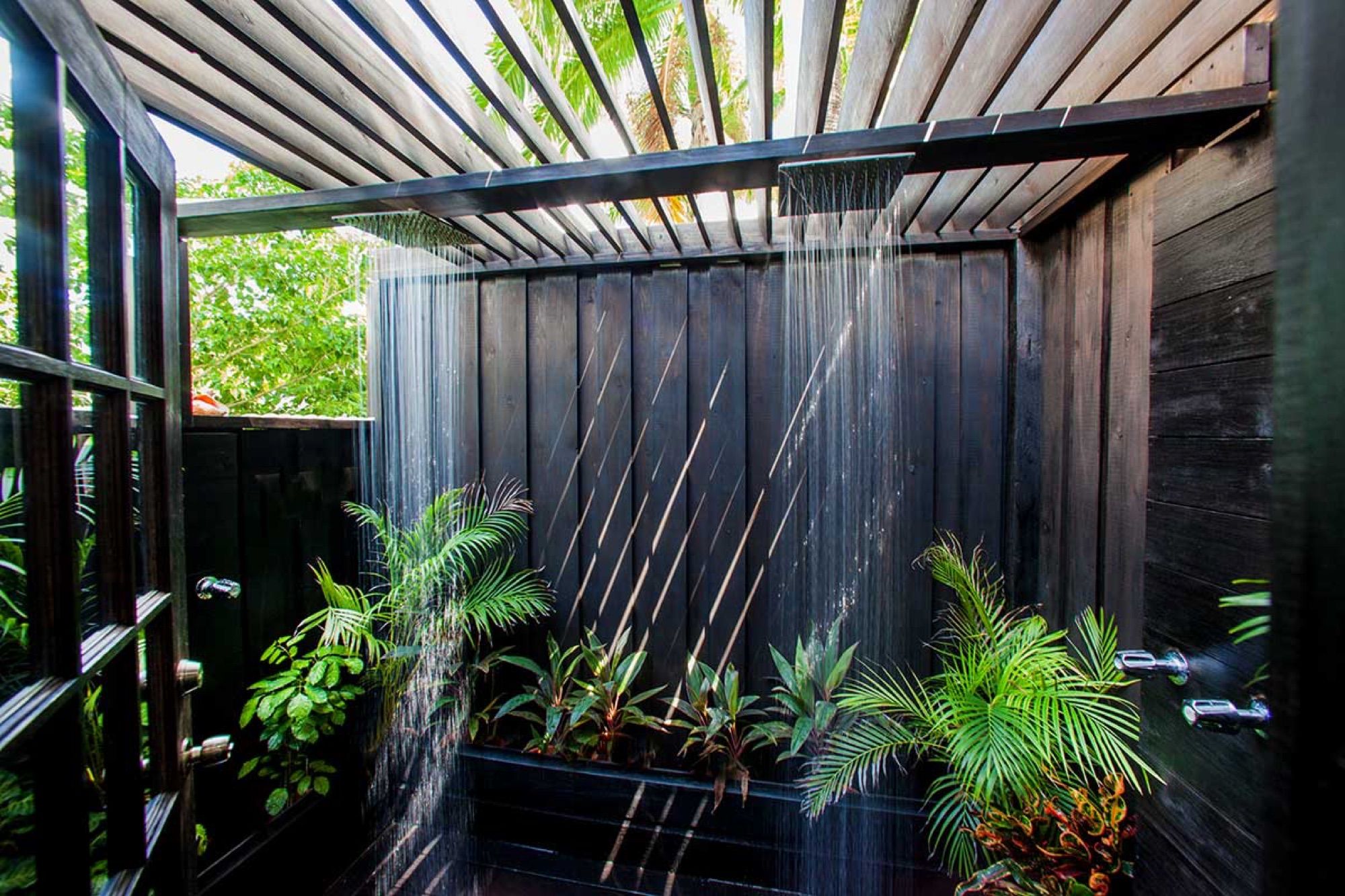 Outdoor shower surrounded by tropical plants