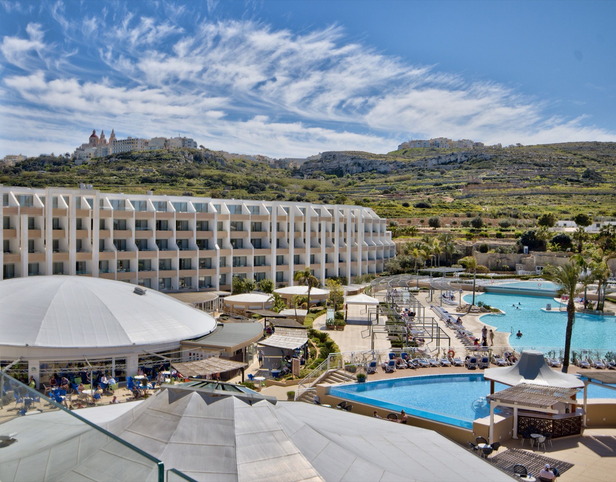 Pool complex with Mellieħa ridge behind