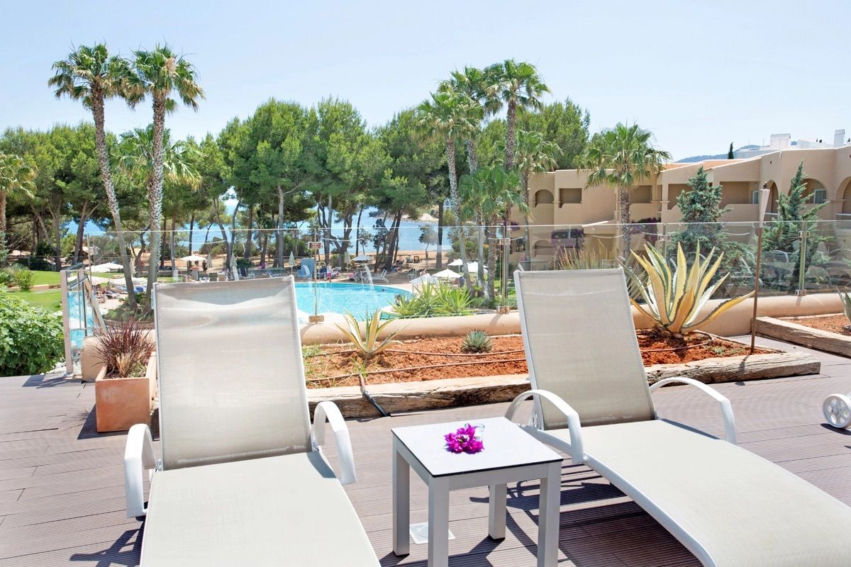 Sun loungers on a terrace above the pool, Grupotel Santa Eulària