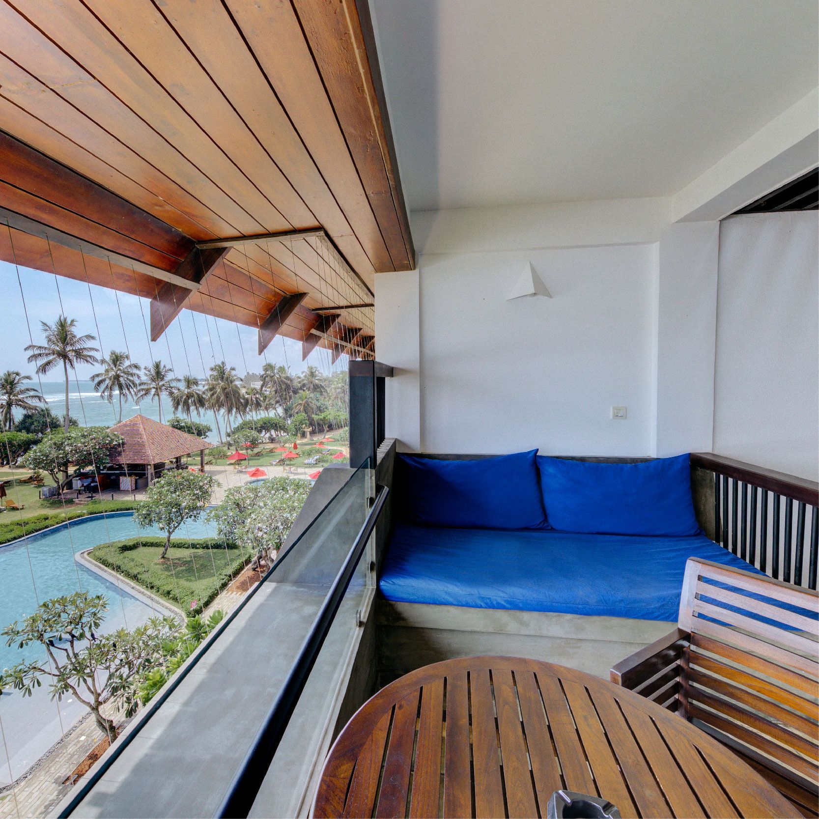 Balcony looking over the pool and palms