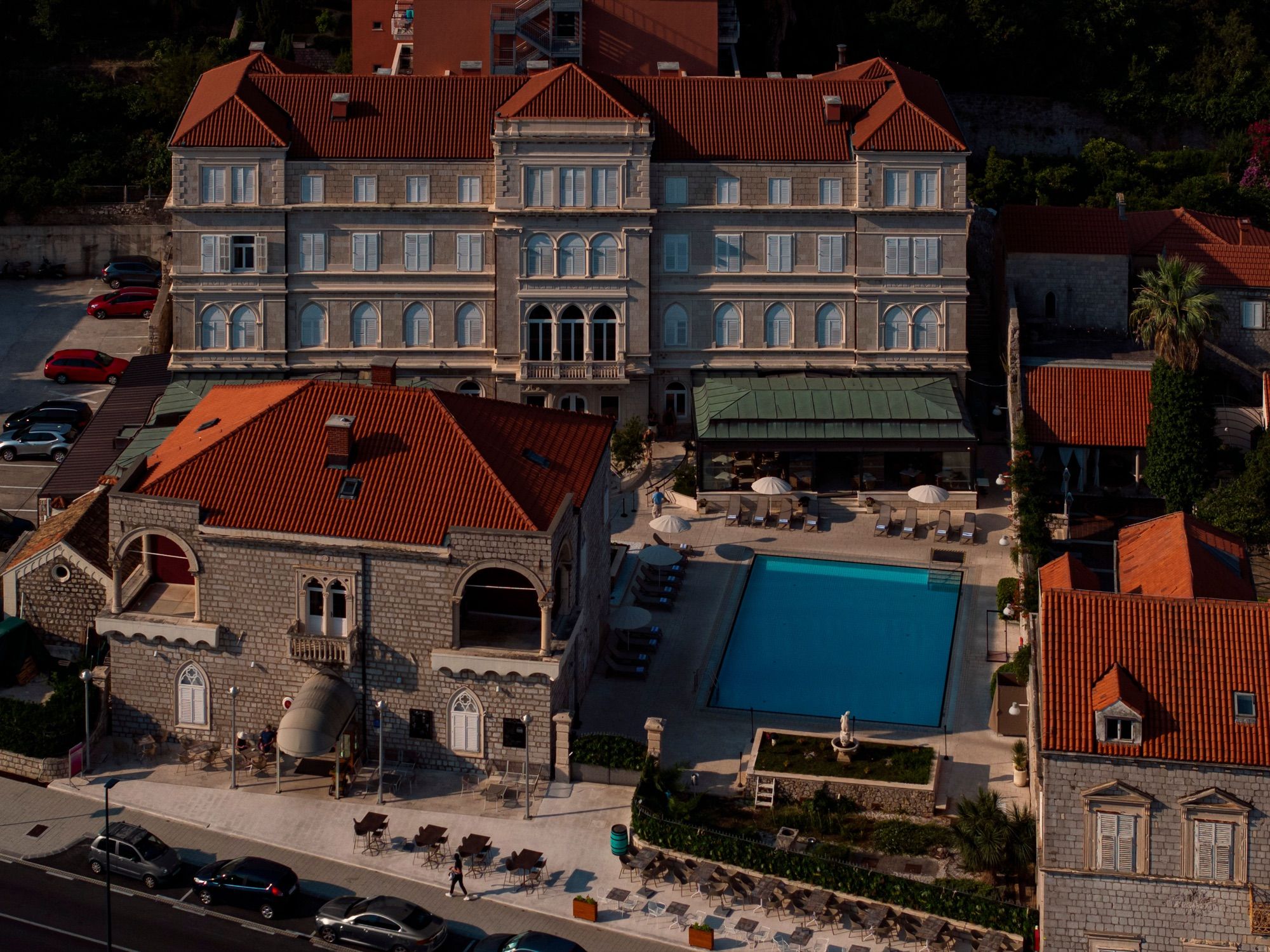 The historic hotel building and pool from above