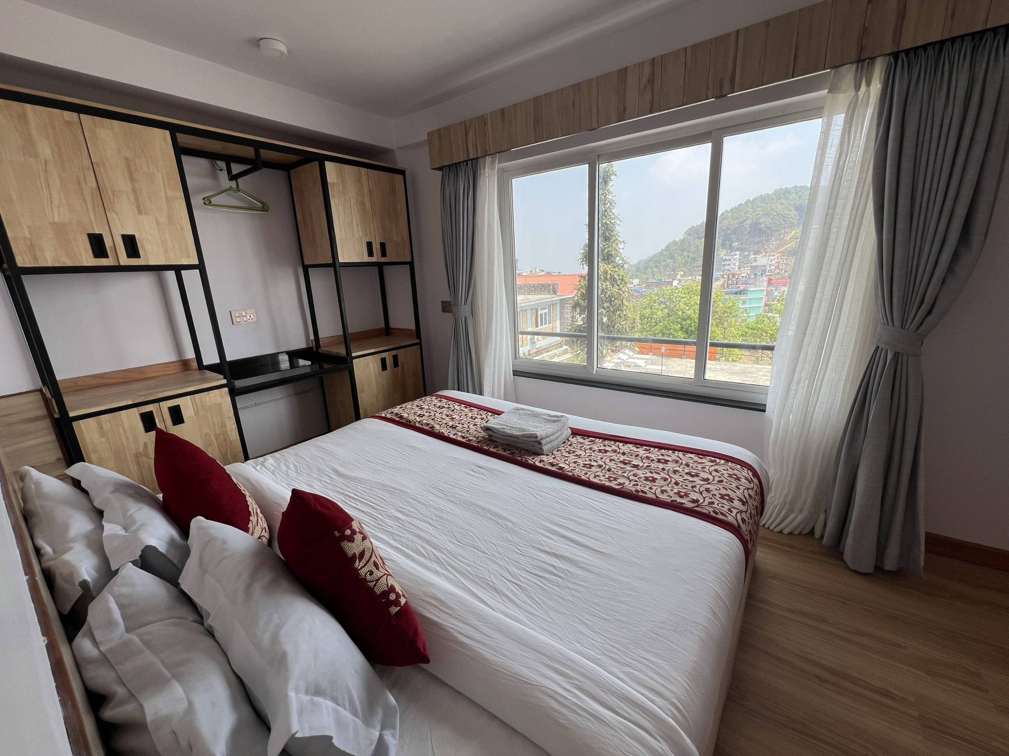 Double room with a window over the green hills
