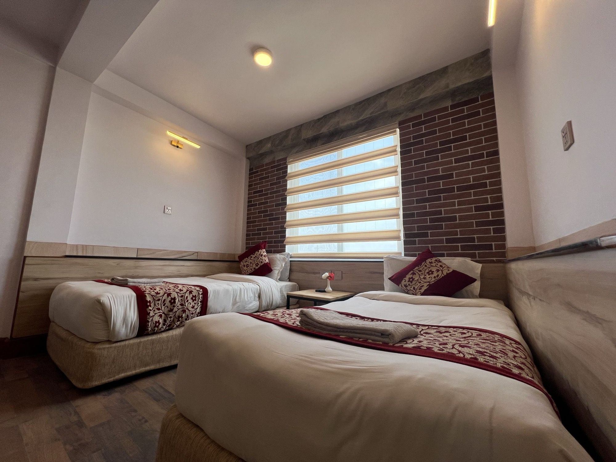 Twin room with a brick feature wall