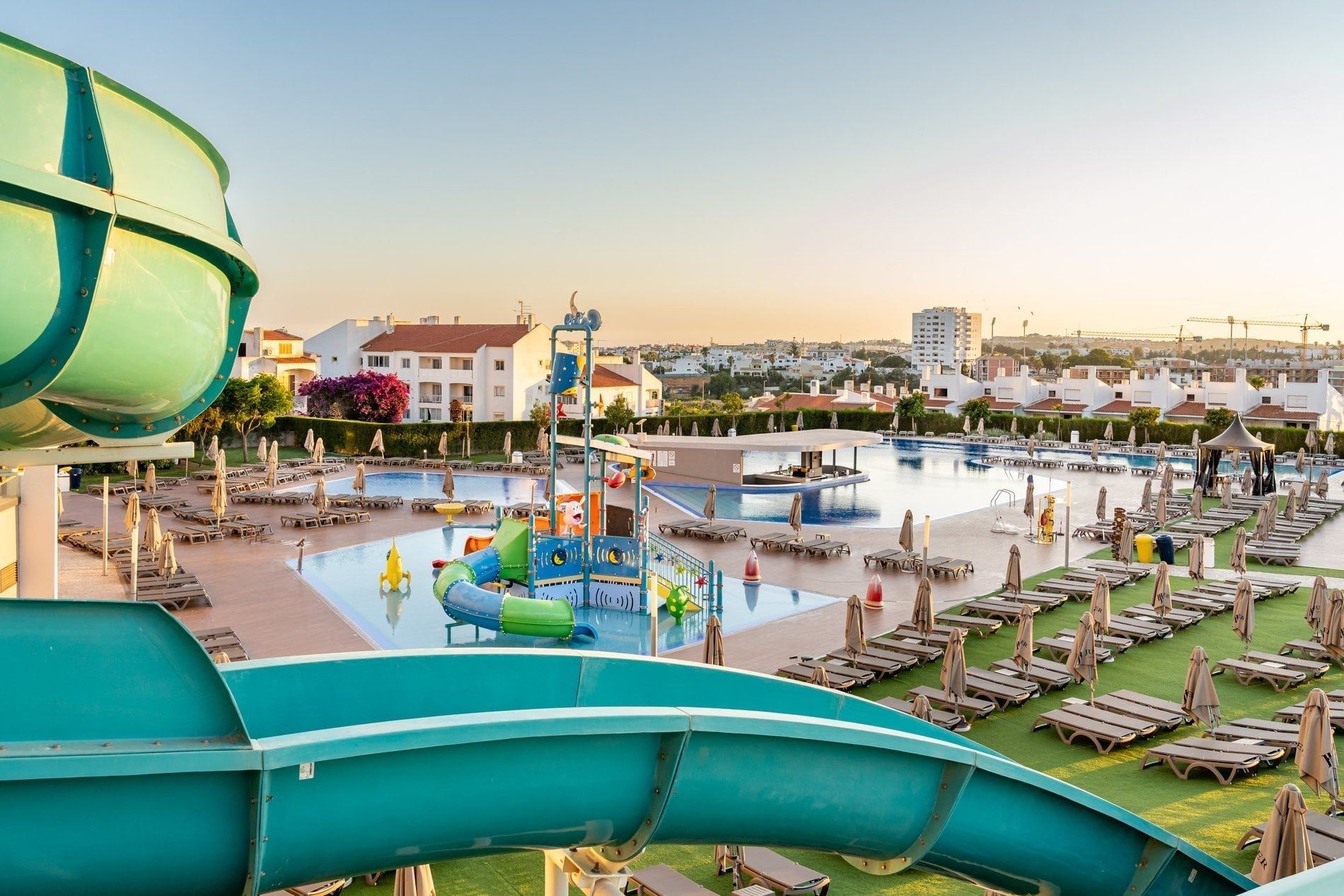 Pool deck and splash park at Jupiter Albufeira at golden hour