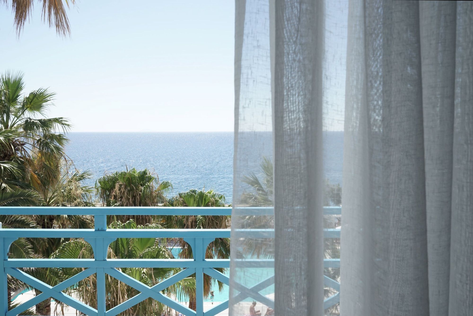 Balcony looking over the palms to the Aegean
