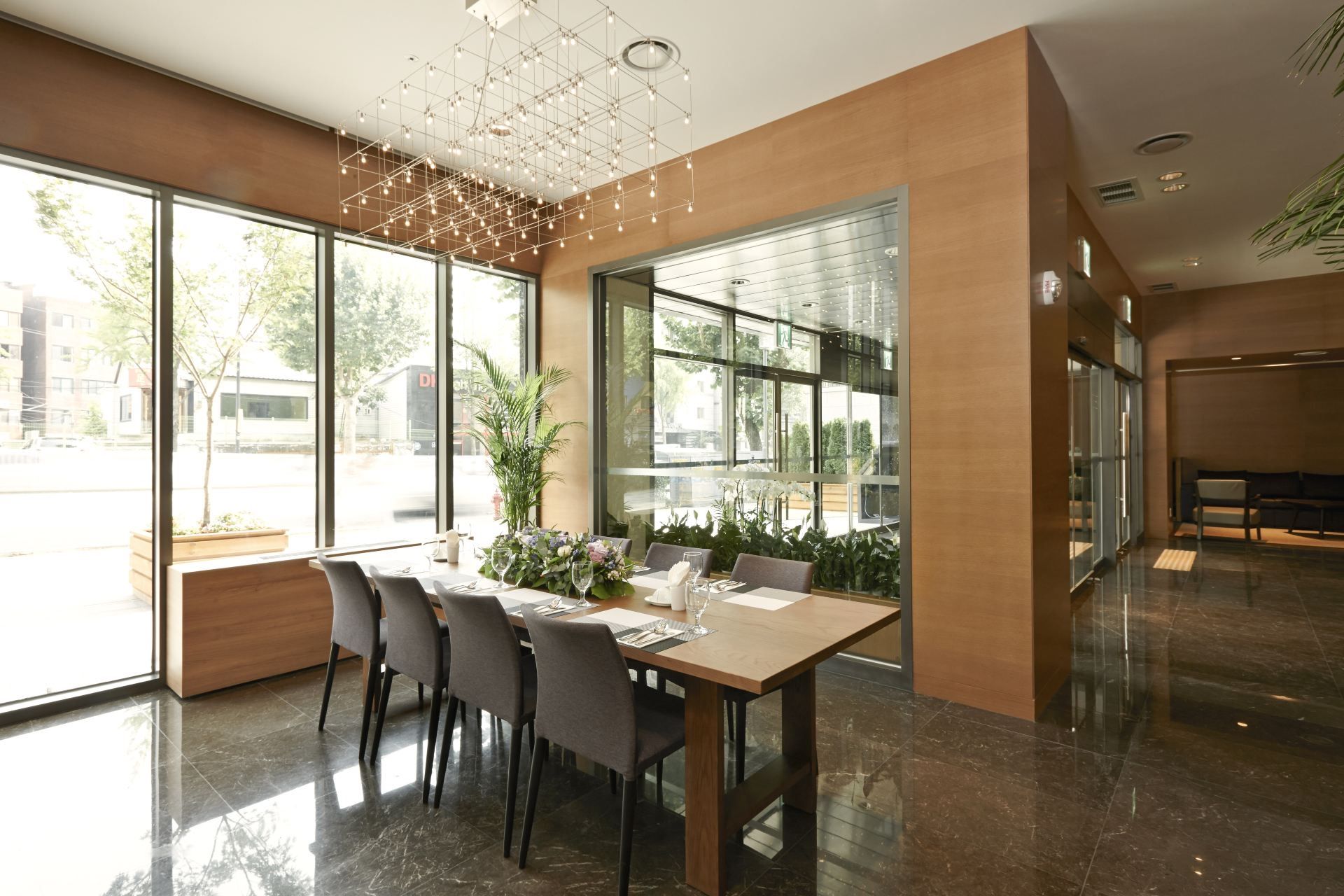 Glass-walled dining space with a long table