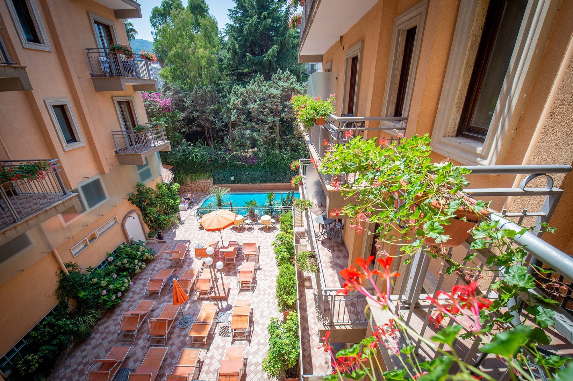 Garden pool seen from a flower-filled balcony