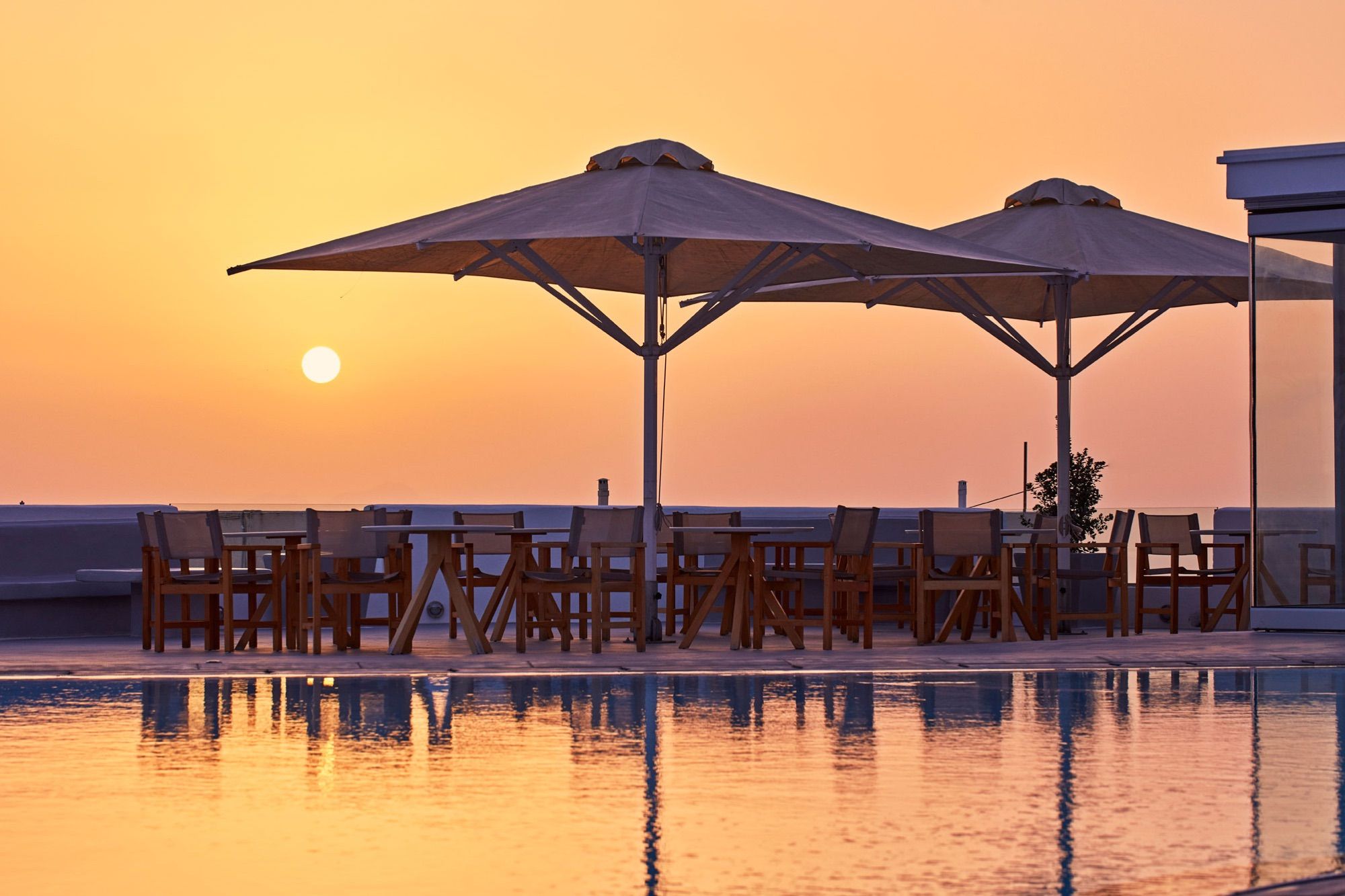 Sunset over the pool terrace at Santorini Palace