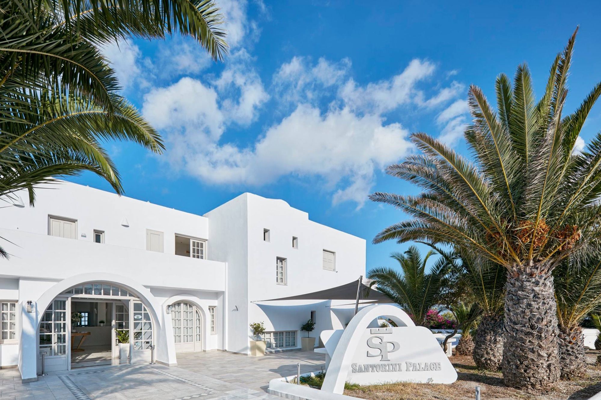 Entrance and palm garden at Santorini Palace
