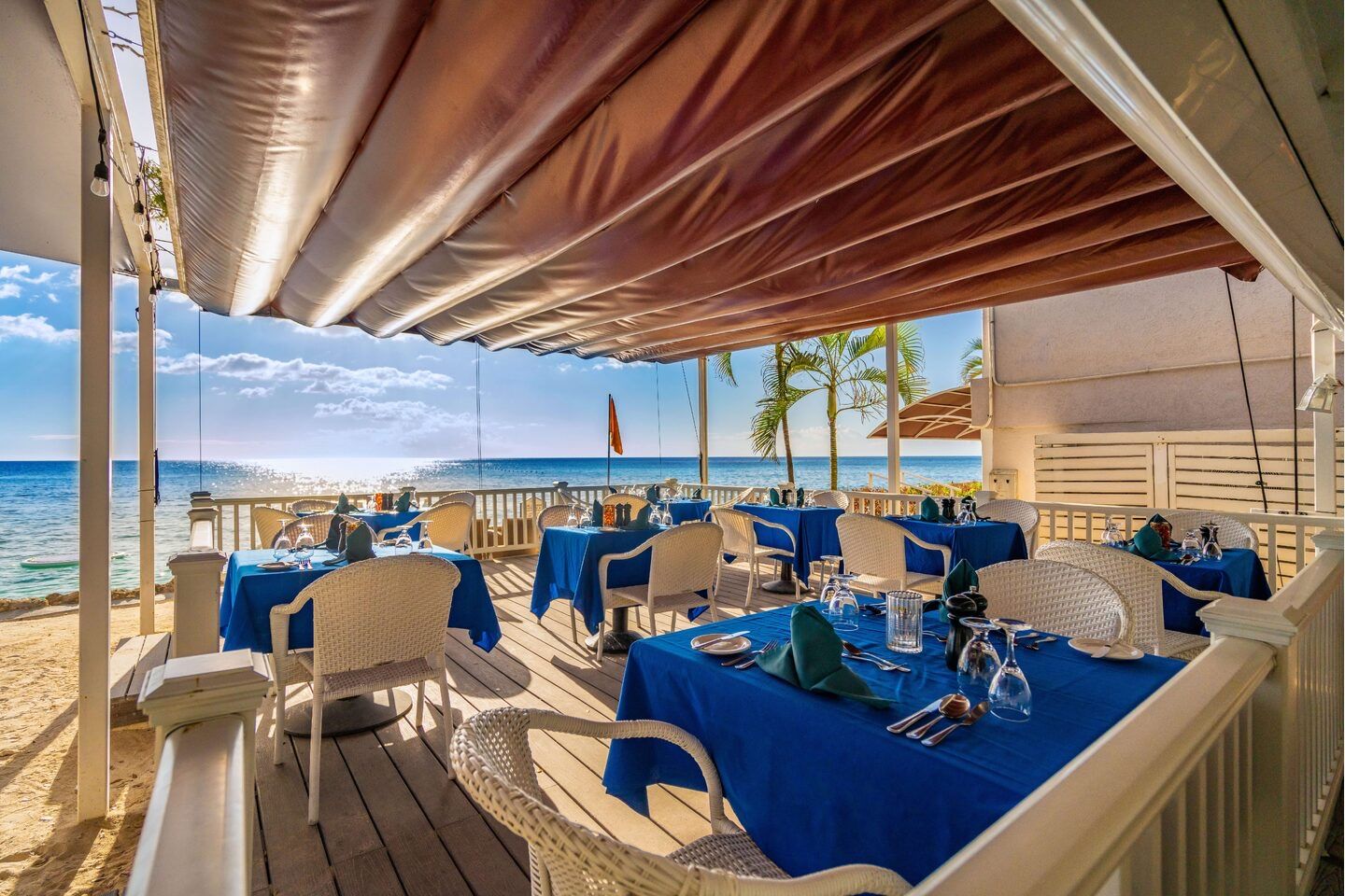 Beachfront restaurant terrace set for lunch