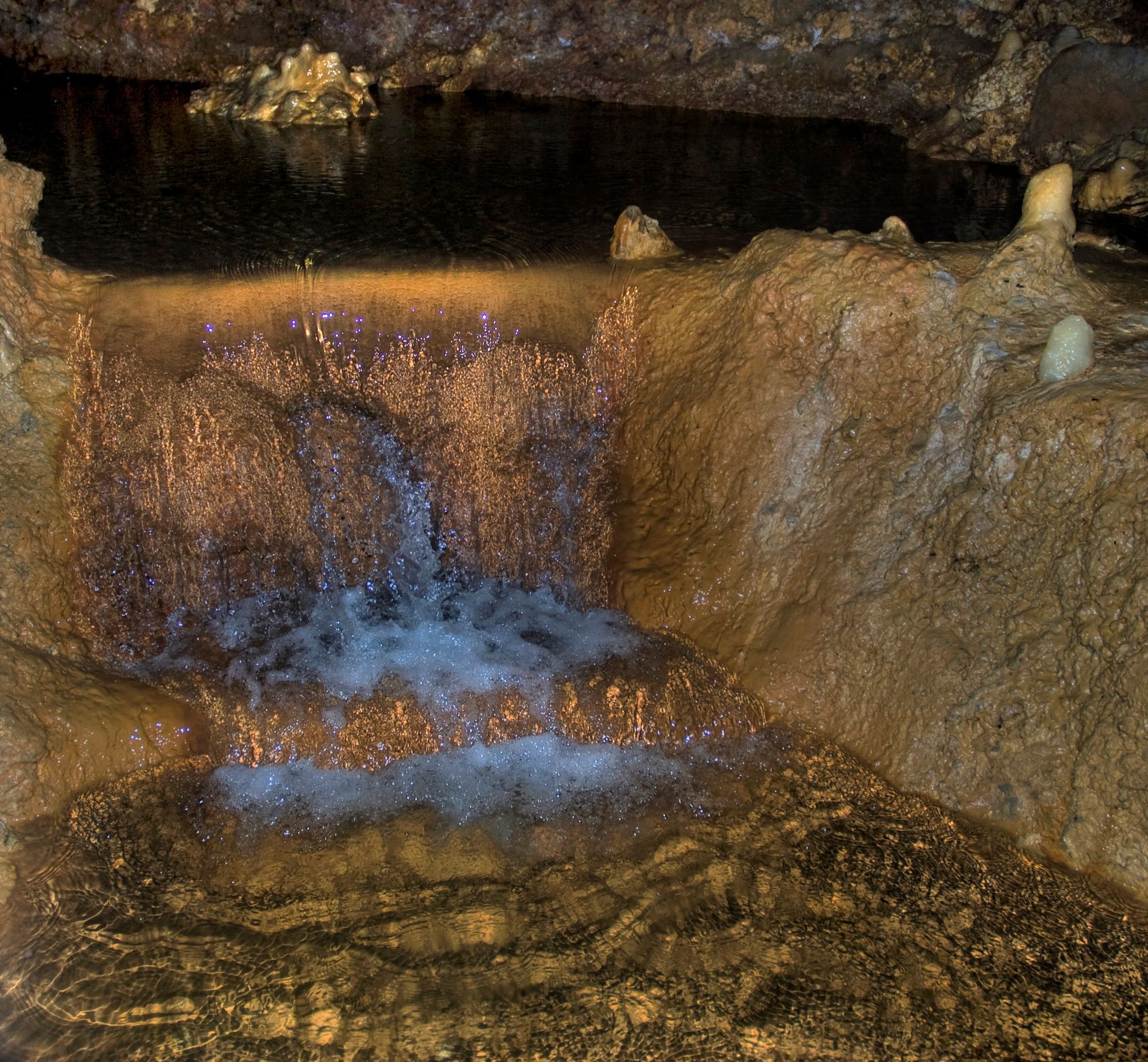 Underground stream falling over limestone in Harrison's Cave