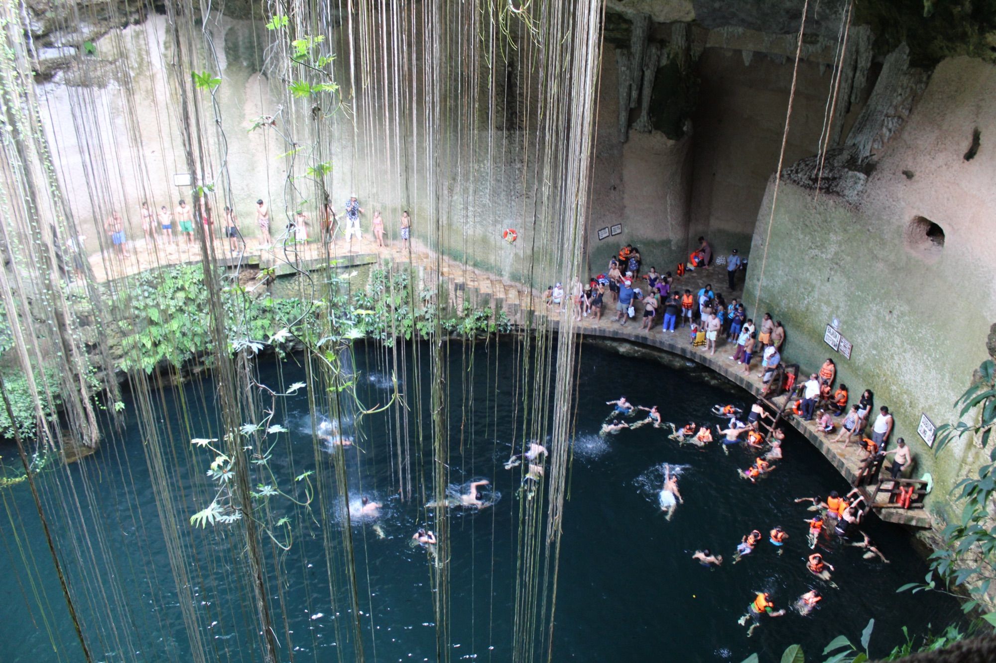 Swimmers in Ik Kil cenote, seen from the rim